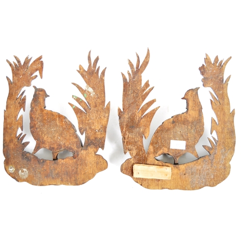 353 - A pair early 20th Century carved oak black forest wall plaques in the form of birds. Central pheasan... 