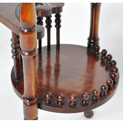 355 - A 19th Century Victorian mahogany side occasional drinks table having an oval top with central tier ... 