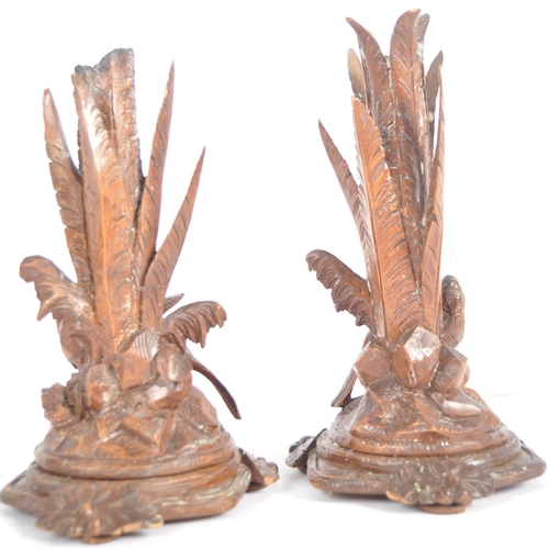 357 - A pair of 19th Century carved black forest candlesticks. Large upright sconce depicting leaves set w... 