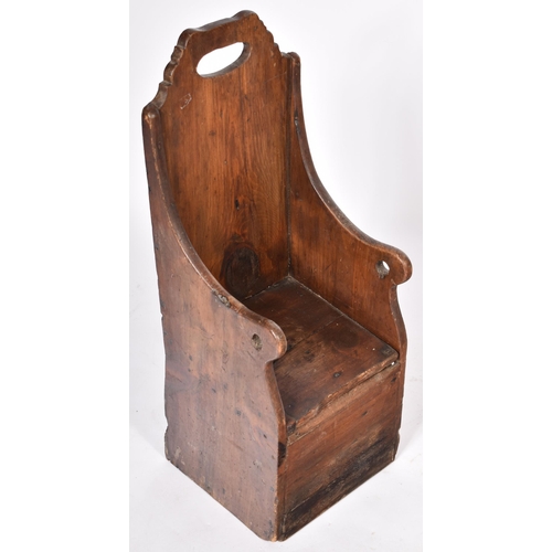 359 - An 18th Century oak and stained pine children's chair having a tall carved backrest with central han... 