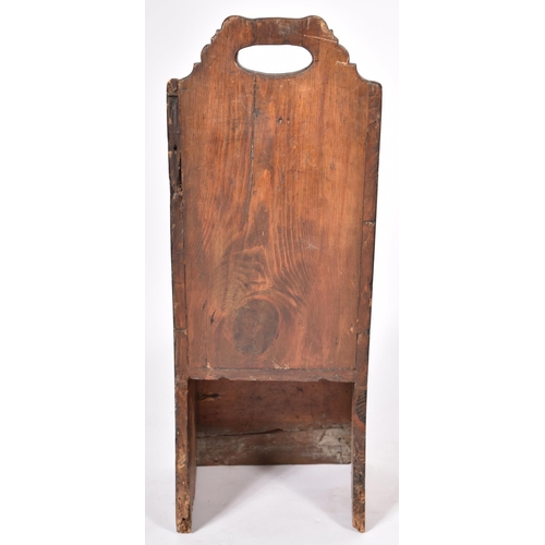 359 - An 18th Century oak and stained pine children's chair having a tall carved backrest with central han... 