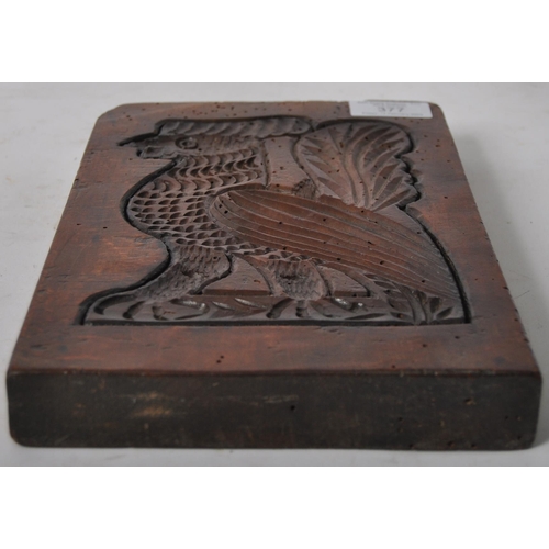 377 - A 19th Century treen gingerbread mould in the form of a griffin. Rectangular form with central depic... 