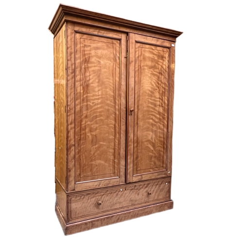 38 - A large 19th Century Victorian satin birch wardrobe in the manner of Maple & Co. Fielded panel doors... 