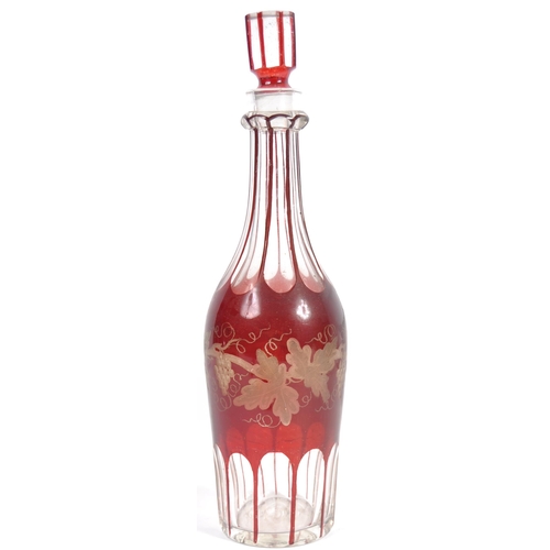 381 - A 19th Century Victorian cranberry glass triple decanter tantalus stand comprising of three etched g... 