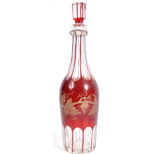 381 - A 19th Century Victorian cranberry glass triple decanter tantalus stand comprising of three etched g... 