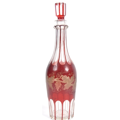 381 - A 19th Century Victorian cranberry glass triple decanter tantalus stand comprising of three etched g... 