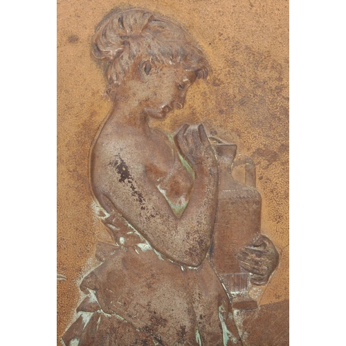 391 - An early 20th Century Art Nouveau cast iron wall plaque cast in relief depicting a classical maiden ... 