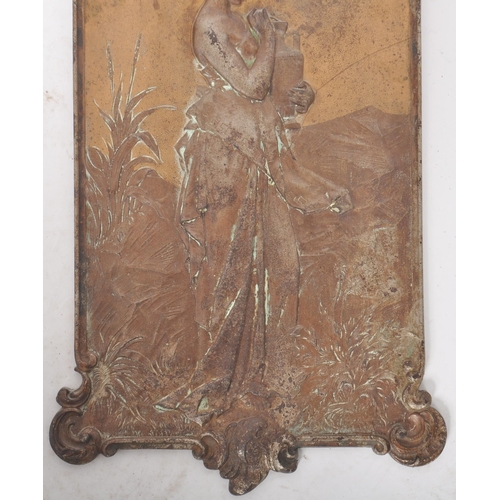 391 - An early 20th Century Art Nouveau cast iron wall plaque cast in relief depicting a classical maiden ... 