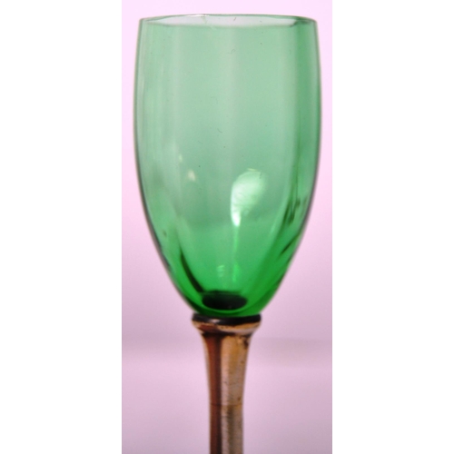 393 - A set of six early 20th Century green glass and silver based liquor drinking glasses. Gently faceted... 