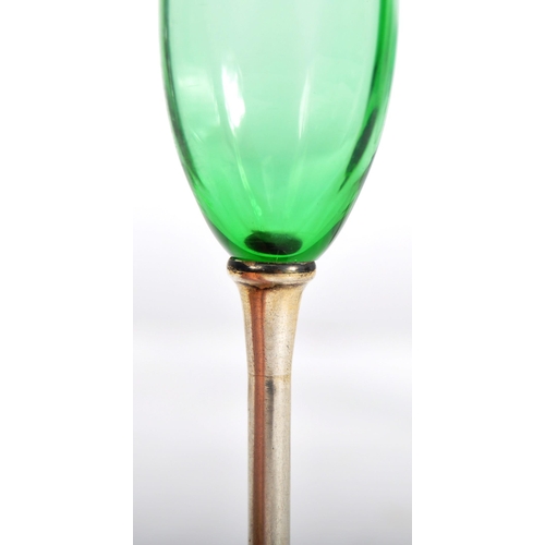 393 - A set of six early 20th Century green glass and silver based liquor drinking glasses. Gently faceted... 