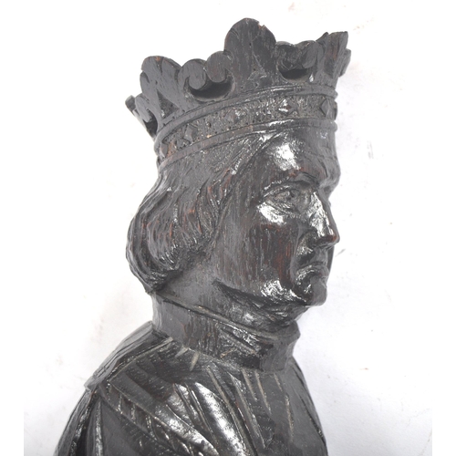 396 - A 20th century oak carved religious figure. An ecclesiastical carving of a knelling King Henry II, w... 