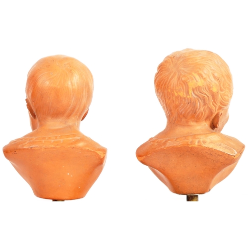 407 - A pair of 19th Century terracotta busts / portrait studies depicting infants / cherub puttis. Orange... 