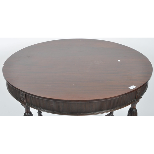 42 - An early 20th Century Edwardian mahogany centre table of circular form. Rosettes to the frieze with ... 