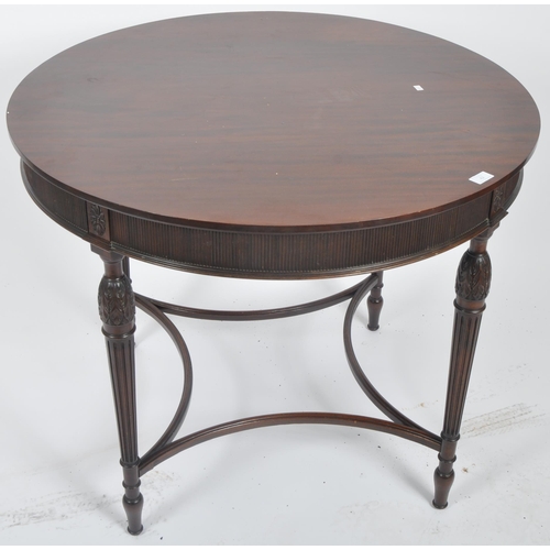 42 - An early 20th Century Edwardian mahogany centre table of circular form. Rosettes to the frieze with ... 