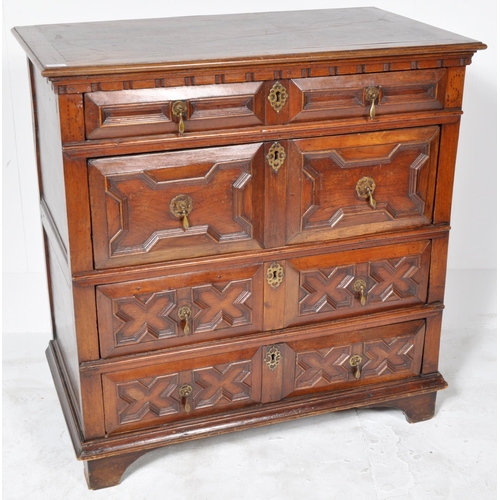 421 - A 17th Century Jacobean solid carved oak chest of drawers having chamfered edge top over a configura... 