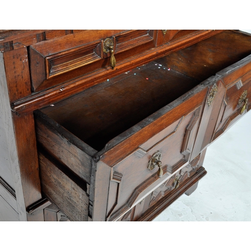 421 - A 17th Century Jacobean solid carved oak chest of drawers having chamfered edge top over a configura... 