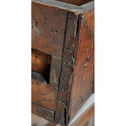 421 - A 17th Century Jacobean solid carved oak chest of drawers having chamfered edge top over a configura... 