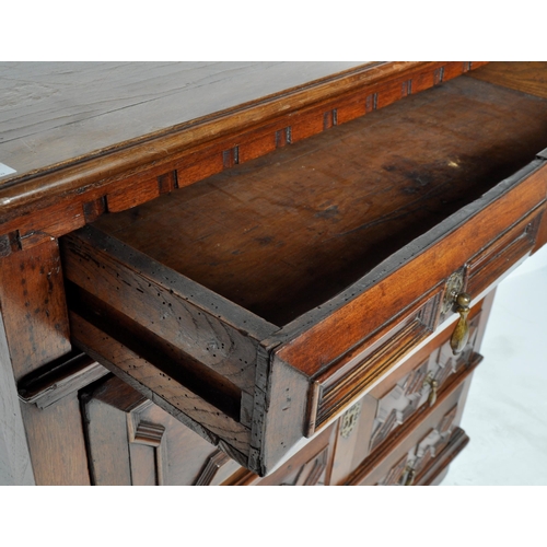 421 - A 17th Century Jacobean solid carved oak chest of drawers having chamfered edge top over a configura... 