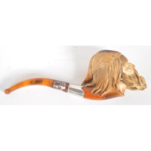 428 - An early 20th century meerschaum tobacco pipe carved in the form of a bearded gentlemen wearing a ni... 