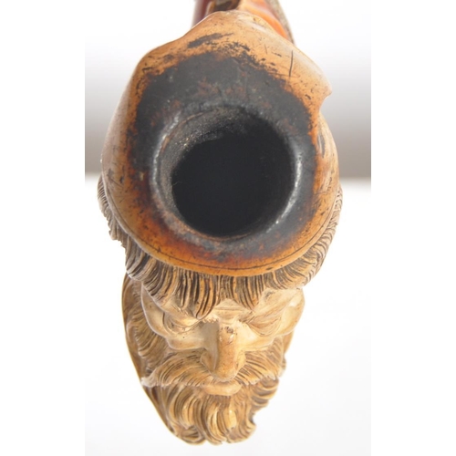 428 - An early 20th century meerschaum tobacco pipe carved in the form of a bearded gentlemen wearing a ni... 