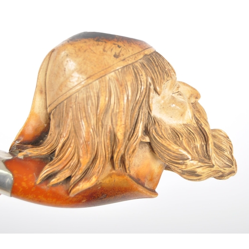 428 - An early 20th century meerschaum tobacco pipe carved in the form of a bearded gentlemen wearing a ni... 