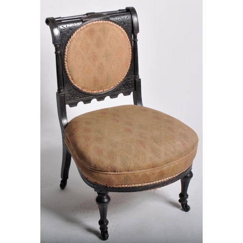 429 - A 19th Century Victorian Aesthetic movement bedroom chair having a carved ebonised frame with cushio... 