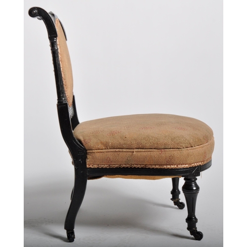 429 - A 19th Century Victorian Aesthetic movement bedroom chair having a carved ebonised frame with cushio... 