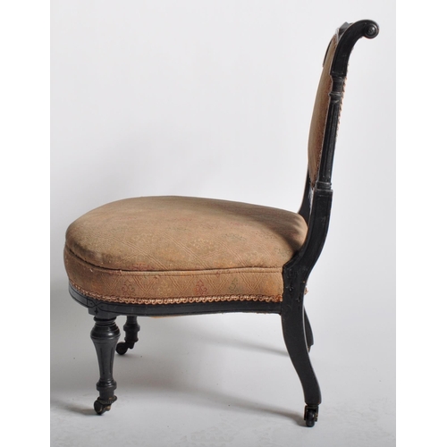 429 - A 19th Century Victorian Aesthetic movement bedroom chair having a carved ebonised frame with cushio... 