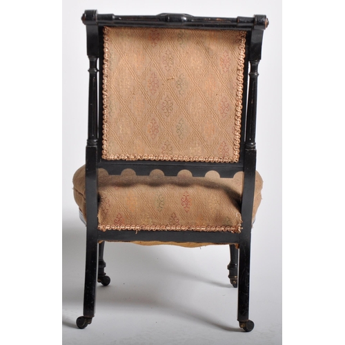 429 - A 19th Century Victorian Aesthetic movement bedroom chair having a carved ebonised frame with cushio... 