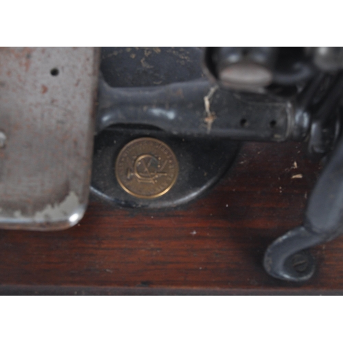 430 - A late 19th century American Willcox and Gibbs of New York hand sewing machine. C-frame hand-cranked... 