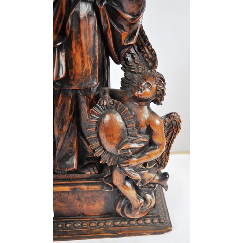 435 - An 18th Century carved walnut figurine group depicting religious figure in hooded robe having winged... 