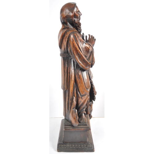 435 - An 18th Century carved walnut figurine group depicting religious figure in hooded robe having winged... 