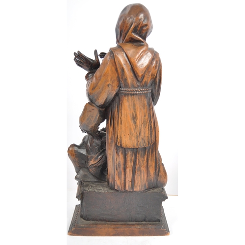 435 - An 18th Century carved walnut figurine group depicting religious figure in hooded robe having winged... 