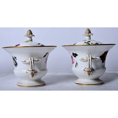 439 - A pair of 19th Century porcelain lidded urns. Acorn finial tops with hand painted floral decoration,... 