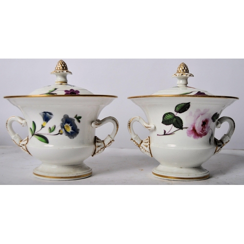 439 - A pair of 19th Century porcelain lidded urns. Acorn finial tops with hand painted floral decoration,... 