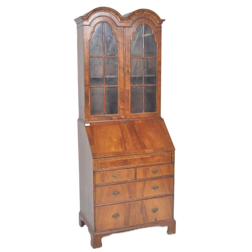 443 - A 20th Century Queen Anne style double dome walnut bureau bookcase having a twin arched top bookcase... 