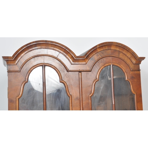 443 - A 20th Century Queen Anne style double dome walnut bureau bookcase having a twin arched top bookcase... 