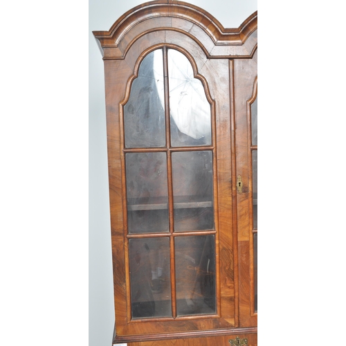 443 - A 20th Century Queen Anne style double dome walnut bureau bookcase having a twin arched top bookcase... 