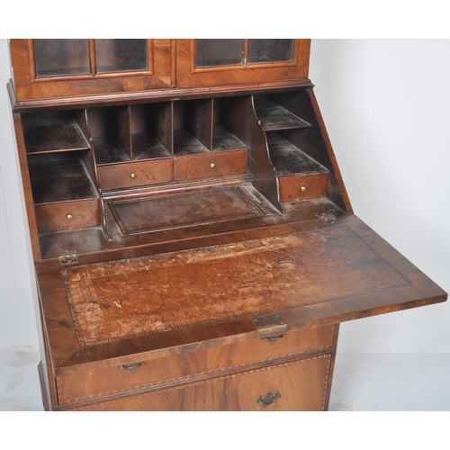 443 - A 20th Century Queen Anne style double dome walnut bureau bookcase having a twin arched top bookcase... 