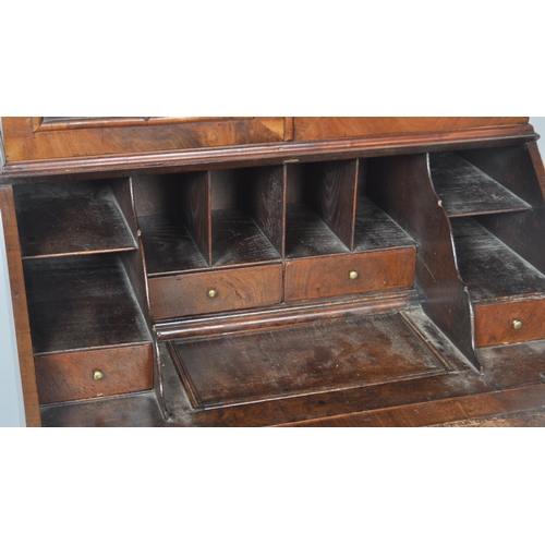 443 - A 20th Century Queen Anne style double dome walnut bureau bookcase having a twin arched top bookcase... 