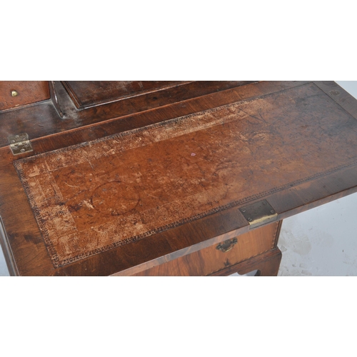 443 - A 20th Century Queen Anne style double dome walnut bureau bookcase having a twin arched top bookcase... 