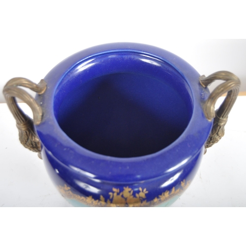 445 - An early 20th Century continental porcelain lidded urn in the Dresden style, having a deep cobalt gr... 