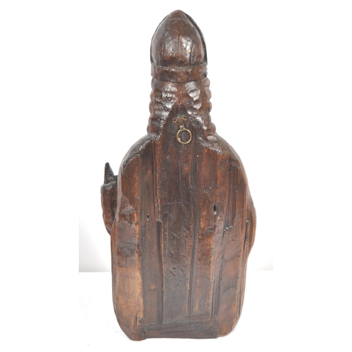 448 - A 19th century oak carving of a religious figure. The ecclesiastical carving depicts a Bishop wearin... 