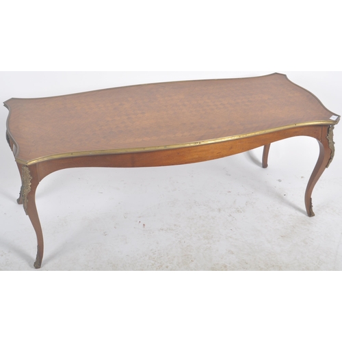 46 - A 20th Century French Empire revival kingwood coffee table / low occasional table. Serpentine shaped... 