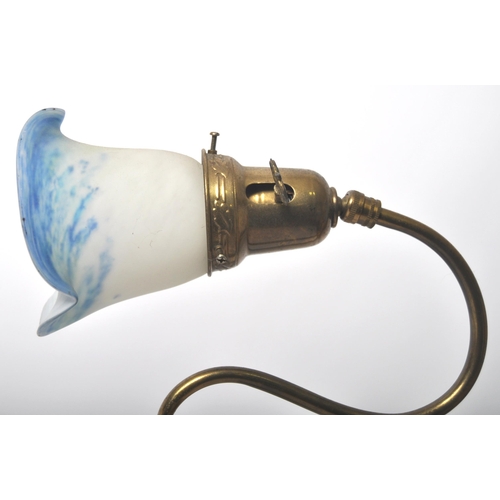 472 - An early 20th Century brass & glass coaching lamp / desk lamp. Coloured glass shade raised on brass ... 