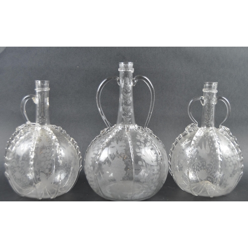 482 - A set of three 19th Century Dutch hand blown glass decanters. Each of bulbous bottle form with appli... 