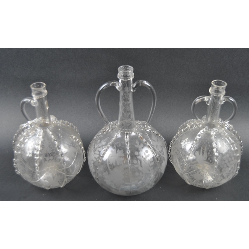 482 - A set of three 19th Century Dutch hand blown glass decanters. Each of bulbous bottle form with appli... 