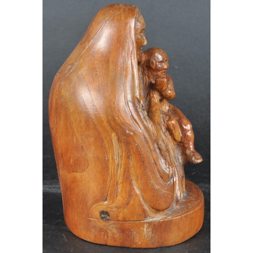 485 - A 20th century walnut carving of Mary & the Child Christ.  Figured posed seated, shawl draped and ho... 