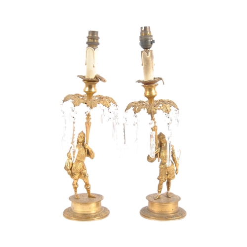 488 - A pair of early 19th Century Regency period bronze ormolu candlesticks in the form of soldiers holdi... 