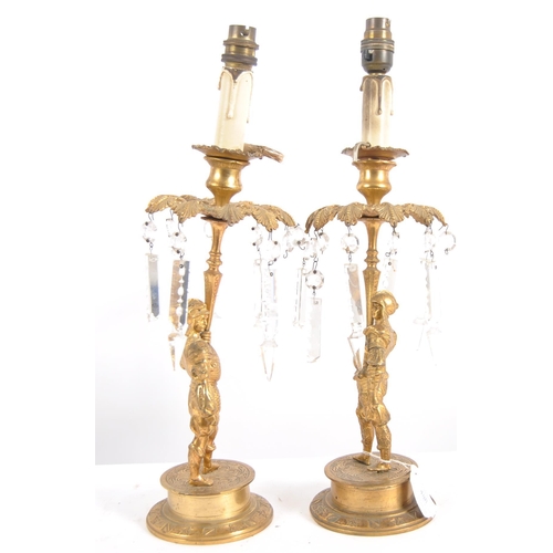 488 - A pair of early 19th Century Regency period bronze ormolu candlesticks in the form of soldiers holdi... 